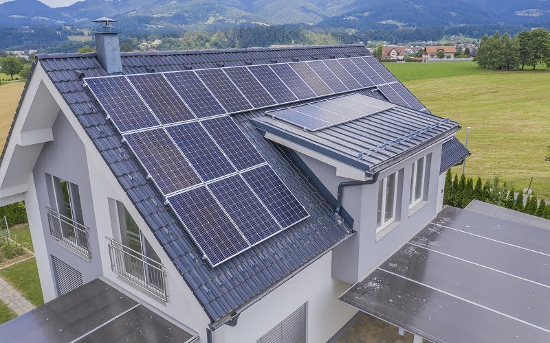 Aerial view of a residential house with rooftop solar panels