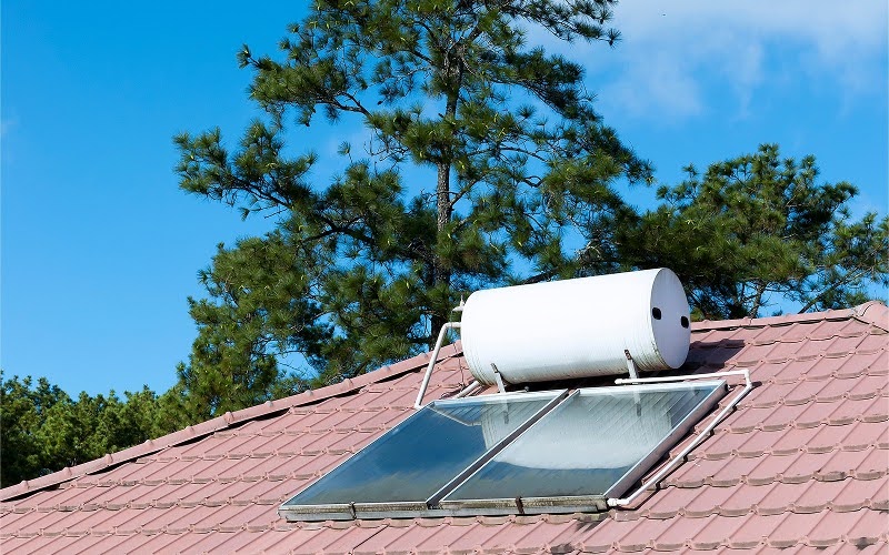 Solar water heater panels installed on residential roof. Solar water heater panels installed on residential roof.