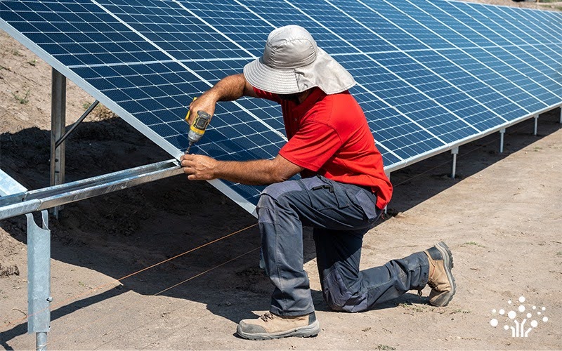 Technician installing solar panels for long term energy performance